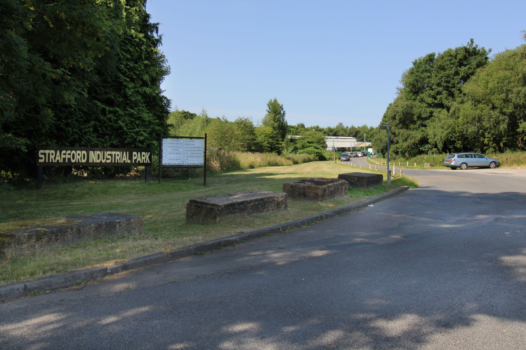 The entrance sign and tree-lined approach to Strafford Industrial Park