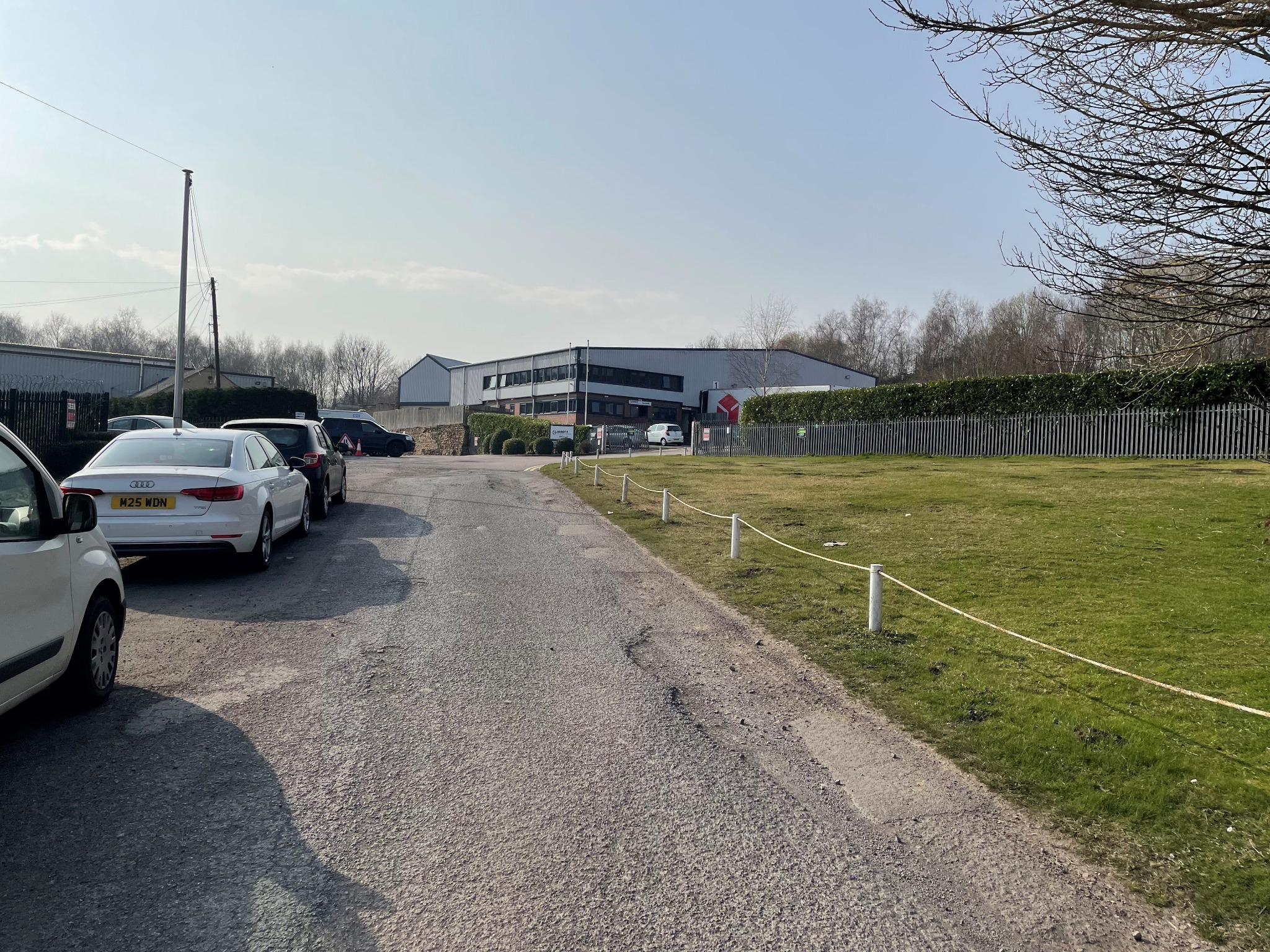 Internal access road with industrial premises and grass verges